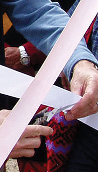 Photo of Man Cutting a Ribbon